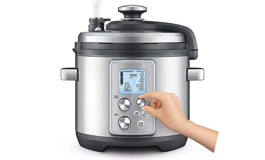 Breville pressure cooker with a hand playing with the buttons