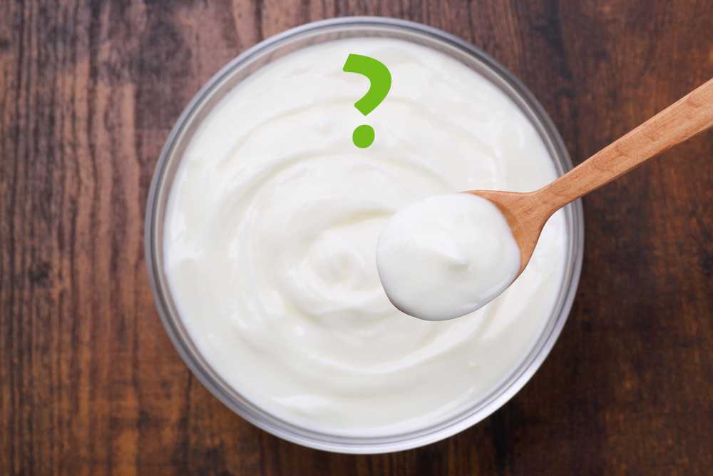 Yogurt bowl with a wooden spoon and a question mark