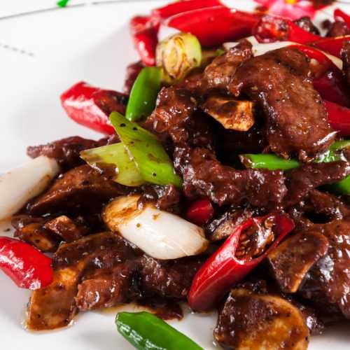 Lamb ribs in honey and soy sauce with red and green chili pepper and onion