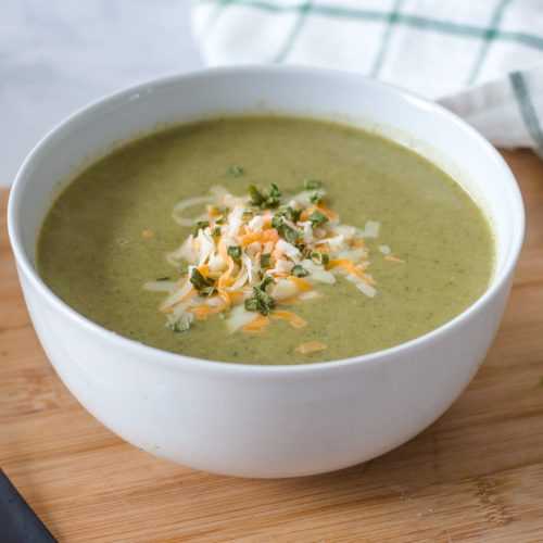 Shredded spinach soup topped with cheese and spices