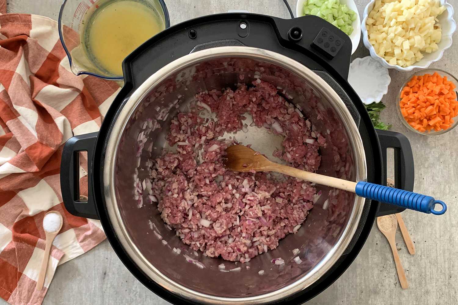 saute ground beef inside instant pot on a table