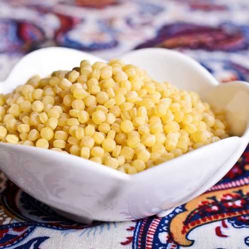 White bowl of Israeli Couscous ready for cooking