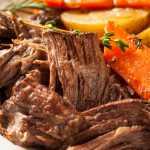 Shredded pot roast with roasted potatoes and carrots with rosemary