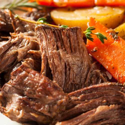 Shredded pot roast with roasted potatoes and carrots with rosemary