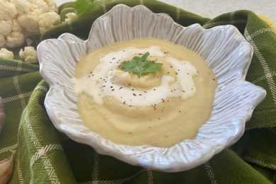 Blended cauliflower soup with cilantro and black pepper on top