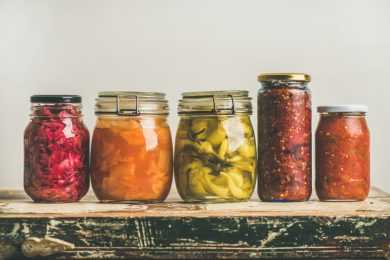 Pickles and other vegetables in jars on one line