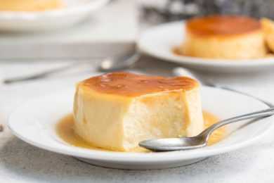 Flan topped with caramel sauce with spoon