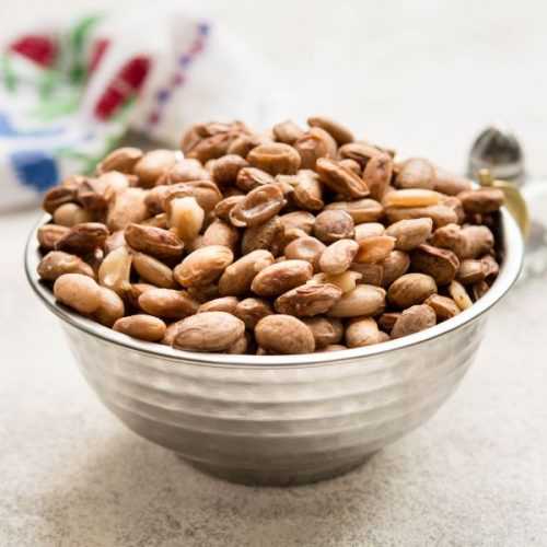 Roasted pinto beans in a metal bowl