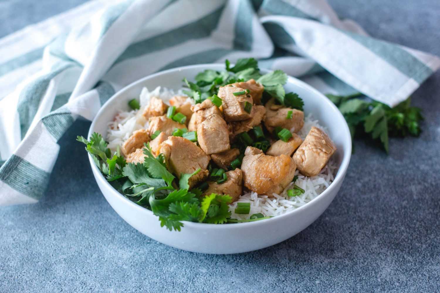 Chicken cubes on jasmine rice topped with chopped parsley and scallion