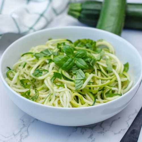 Zucchini Noodles with basil and parmesan cheese on top