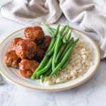 Meatballs in BBQ sauce alongside green beans and basmati rice