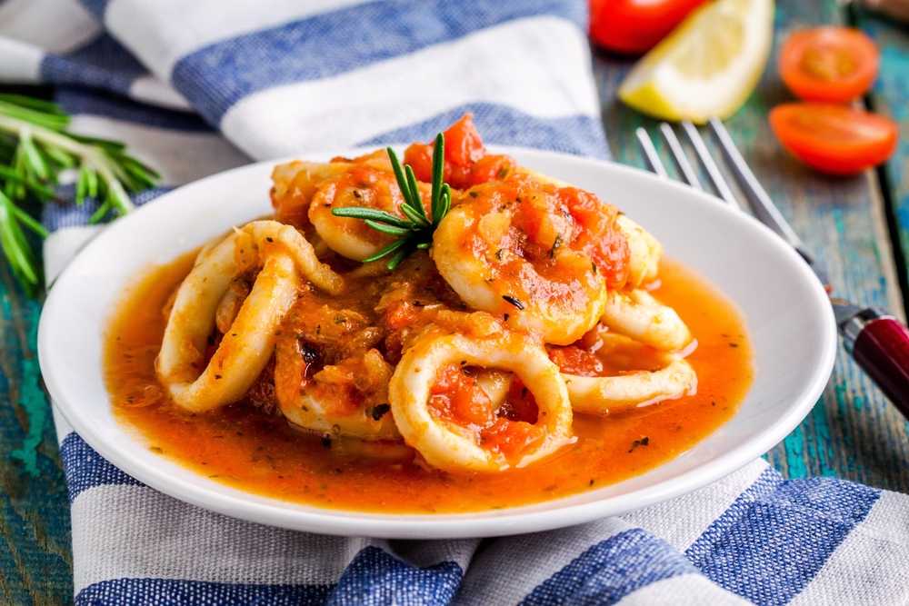 Calamari in red sauce topped with crushed tomatoes, red pepper flakes and sage