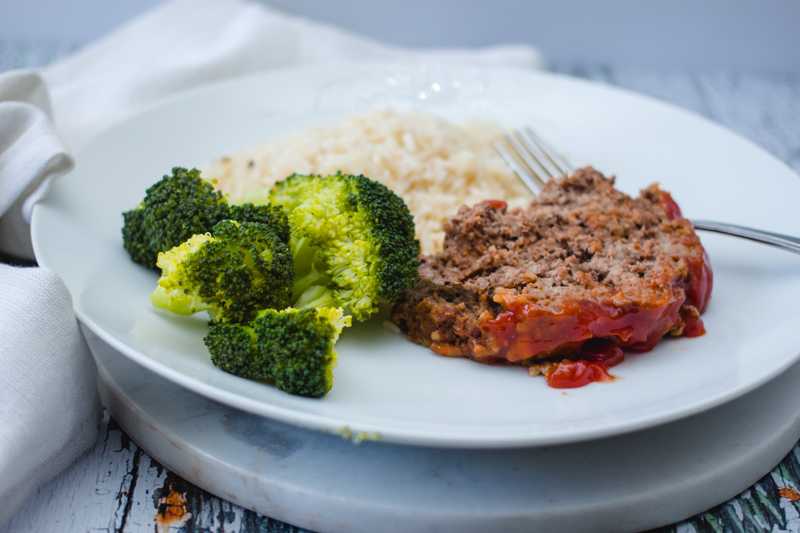 Meatloaf in red sauce alongside with jasmine rice and steamed broccoli