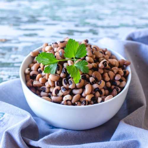 Black eyed peas topped with parsley in white bowl