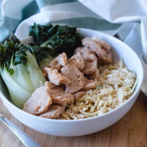 Seitan chunks served with rice a roni and seamed bok choy