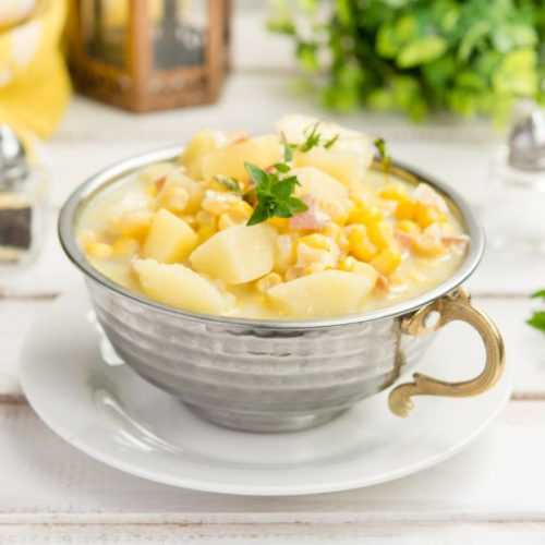Potato corn chowder with bacon and mint on top