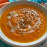 Carrot Soup with sour cream on top and carrots on side