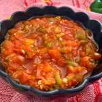Red salsa made of bell peppers, jalapeno peppers, onion and tomatoes