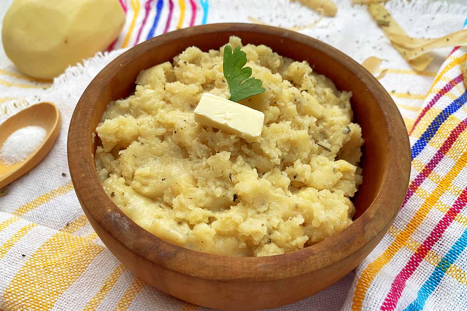 Instant Pot Mashed Potatoes in a brown bowl topped with butter