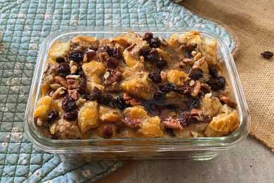 casserole dish full of Instant Pot Bread Pudding with raisins and nuts on top