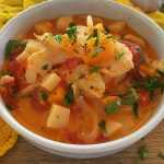 Fish stew with sea bass cubes, carrot, onion, tomatoes, spices and chopped parsley
