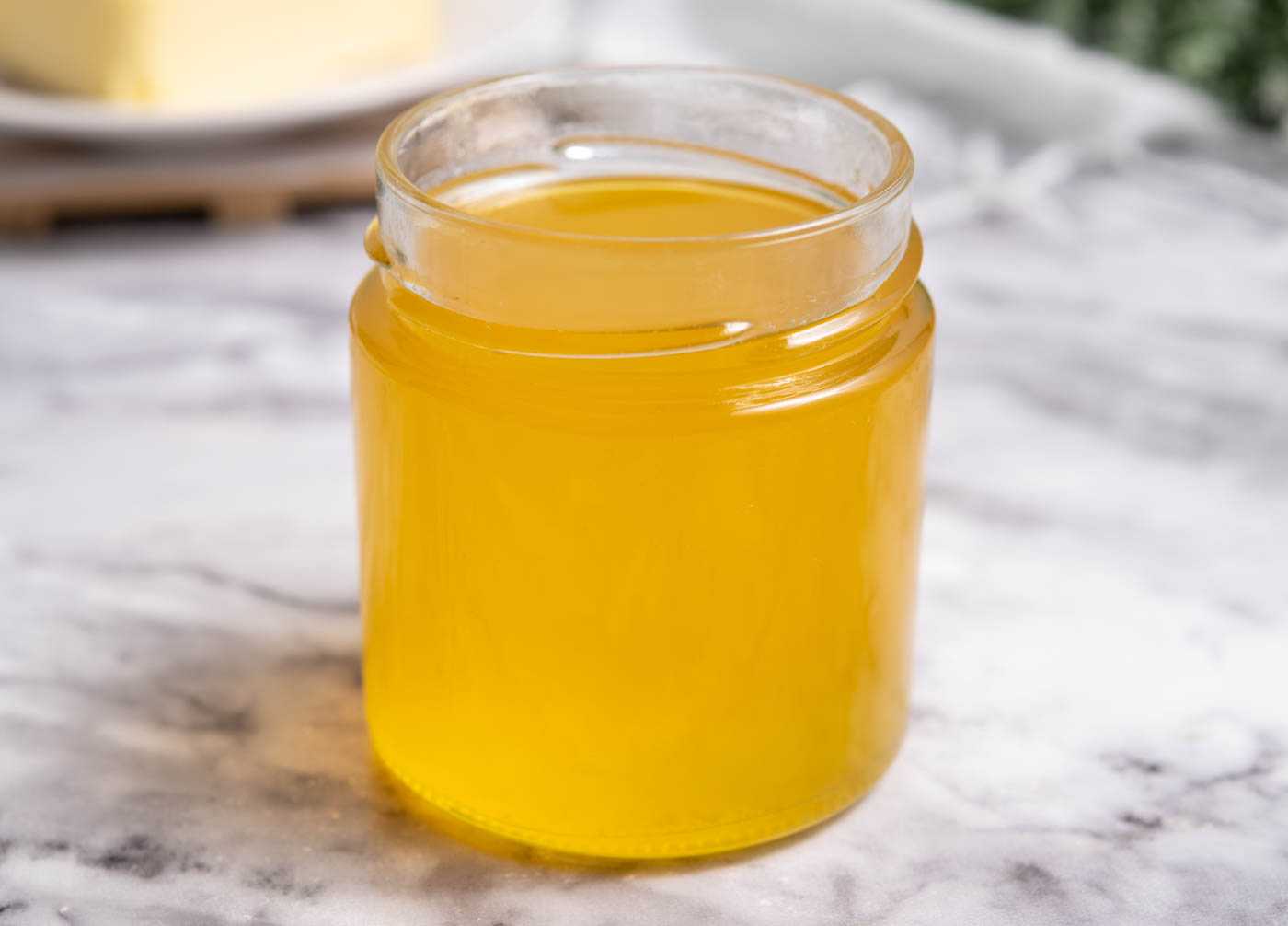 Homemade ghee in a glass jar top view