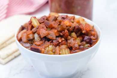 Eggplant cubes mixed with chopped bell peppers, onion and celery, black olives and spices in red sauce