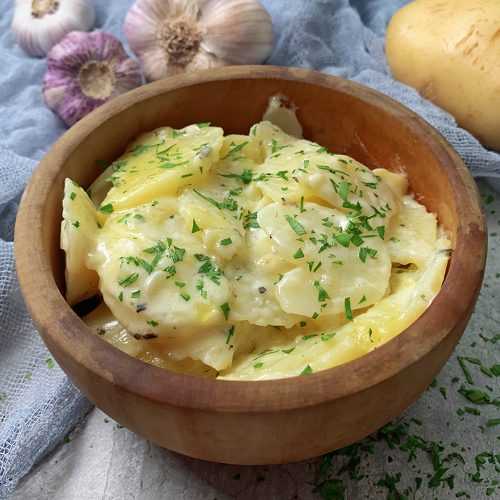 brown bowl full of Instant Pot Scalloped Potatoes recipe