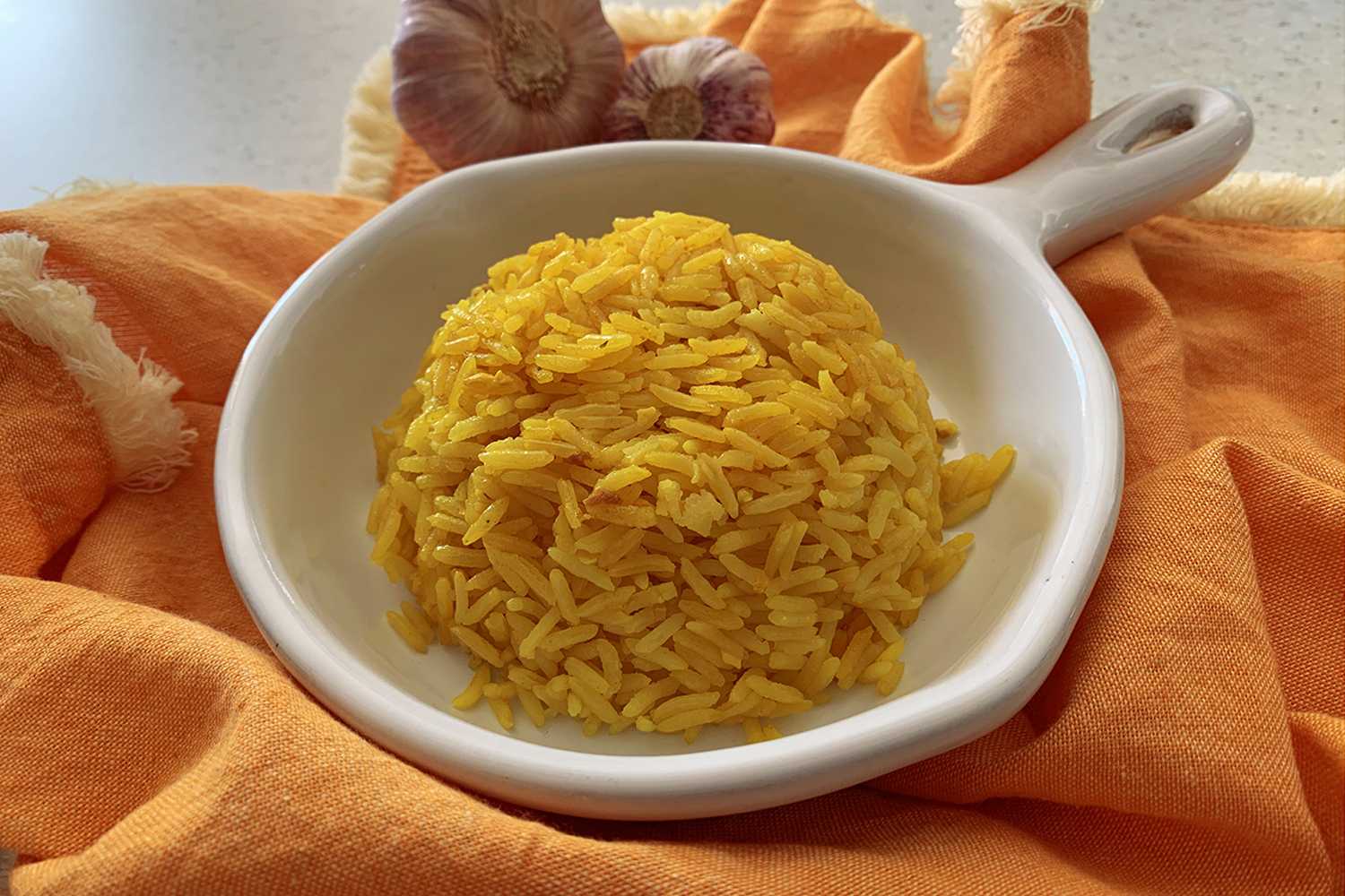 Yellow rice in a middle of white bowl 