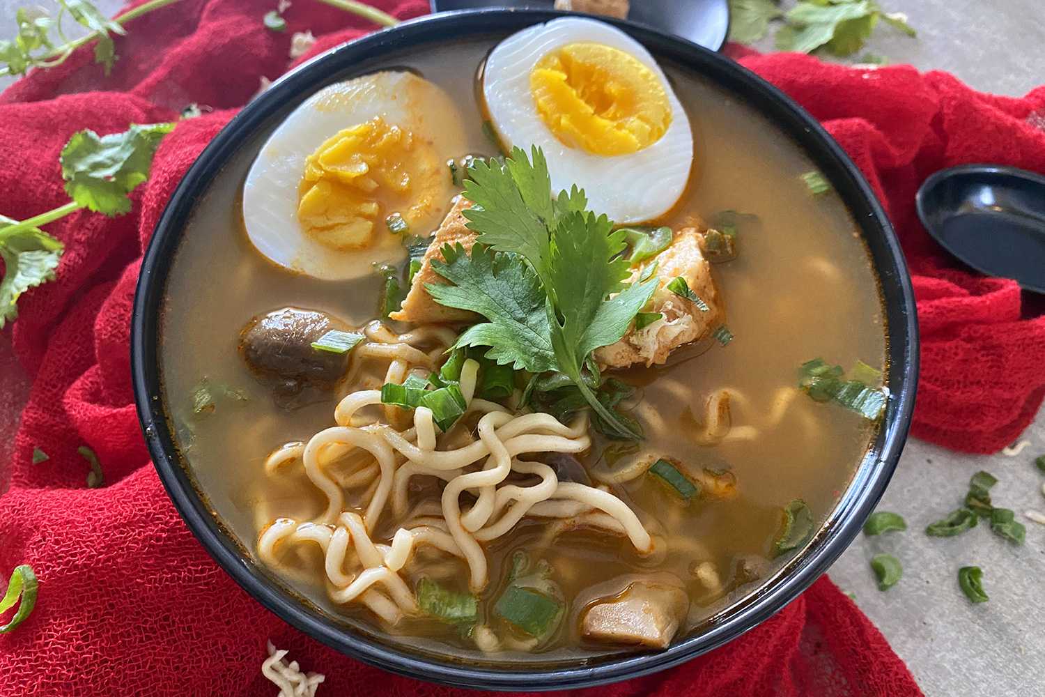 Bowl of ramen with hard boiled eggs and chicken.