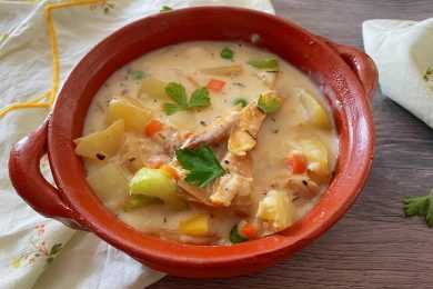 pot pie soup filled with shredded chicken, potato cubes, celery and peas