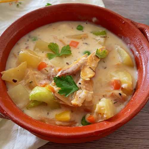pot pie soup filled with shredded chicken, potato cubes, celery and peas