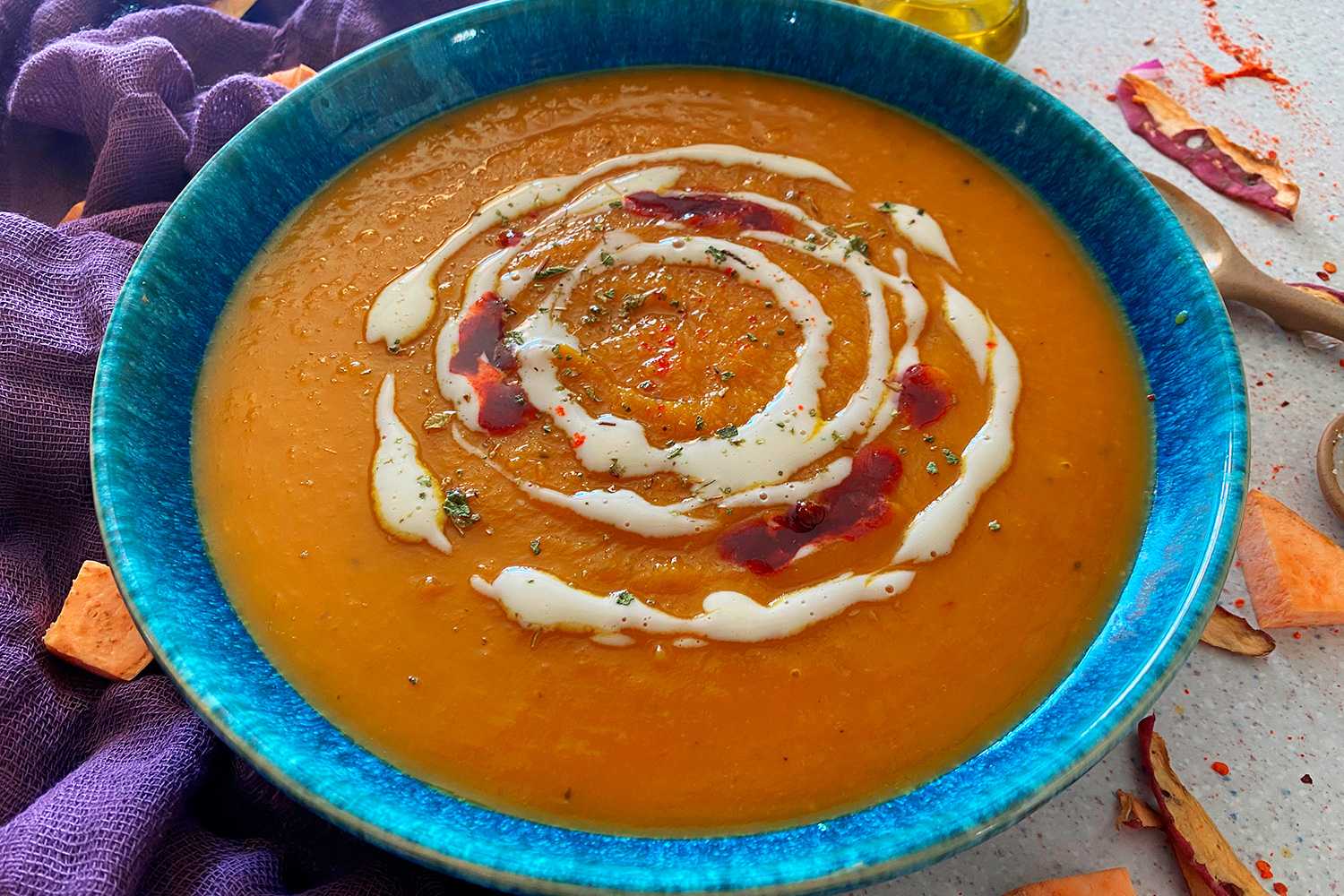Blended orange soup topped with sour cream and spices