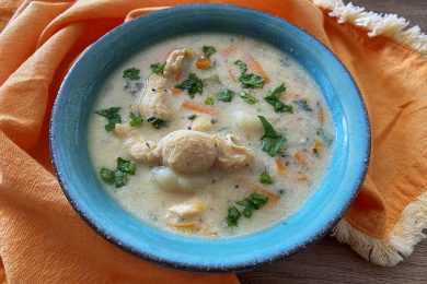 gnocchi soup with chicken served in a blue bowl