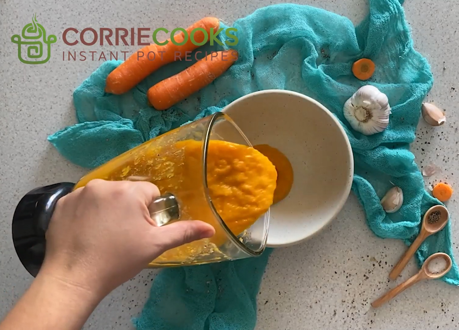 Pouring blended soup from a food processor into a bowl.