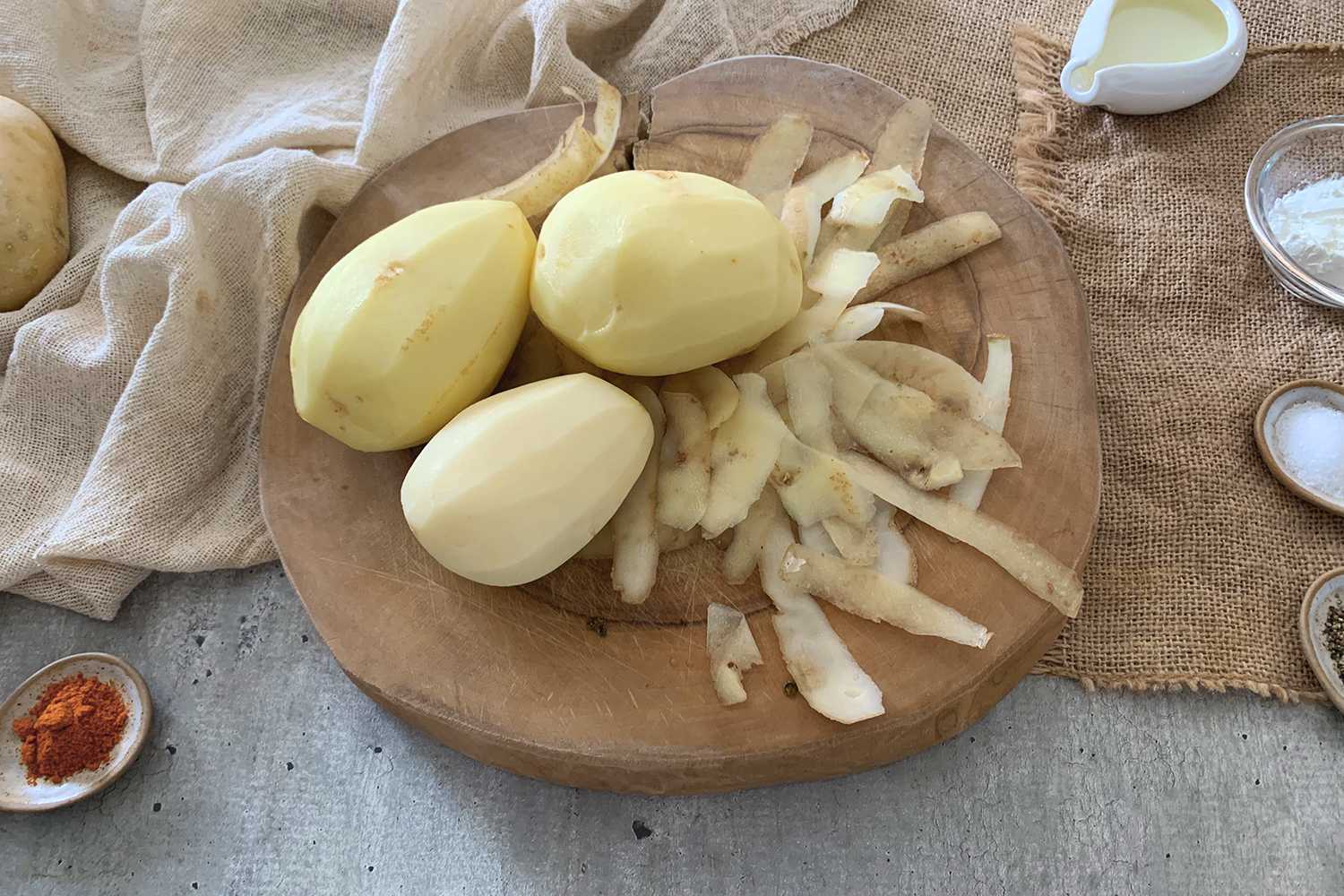 peeled potatoes on a wooden board