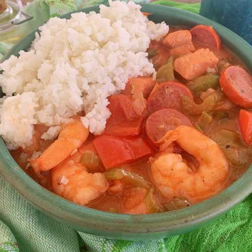 bowl of instant pot chicken gumbo with a side of rice