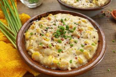 Corn in butter sauce topped with green onion and spices