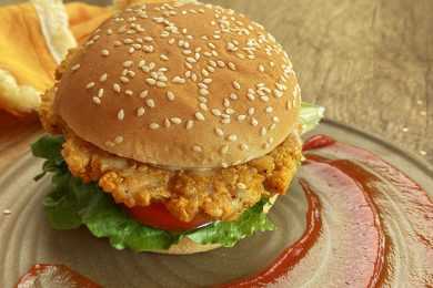 turkey burger in a bun with ketchup, tomato and lettuce