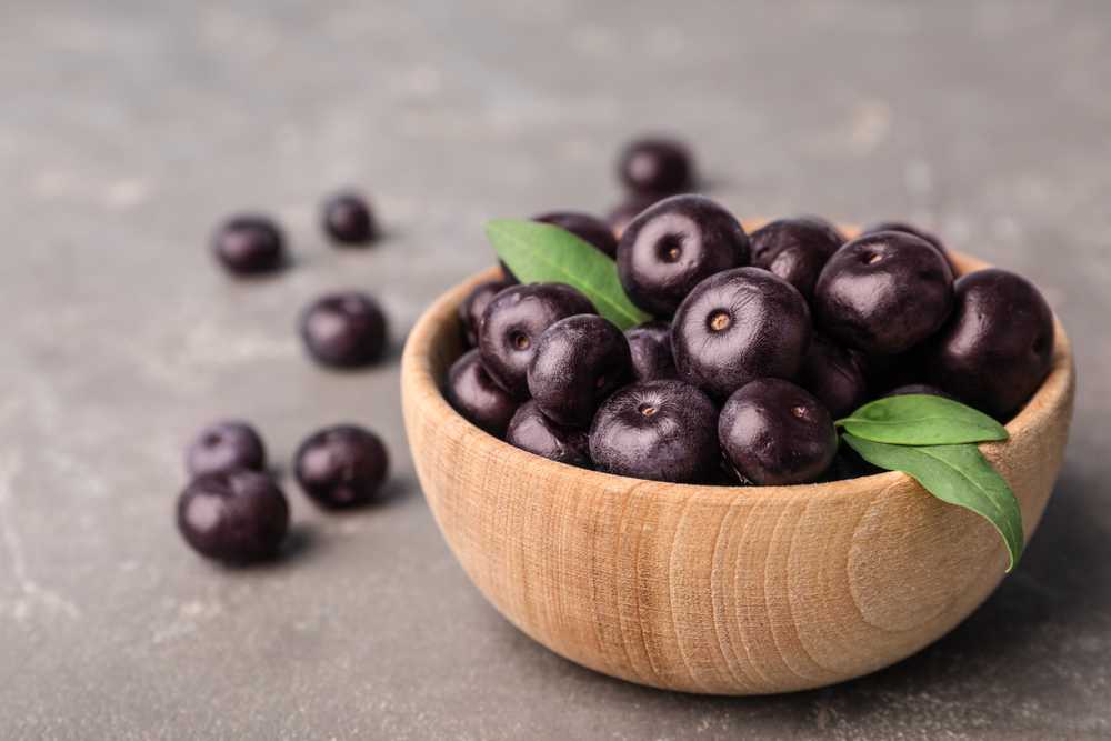 Acai berries in a wooden bowl