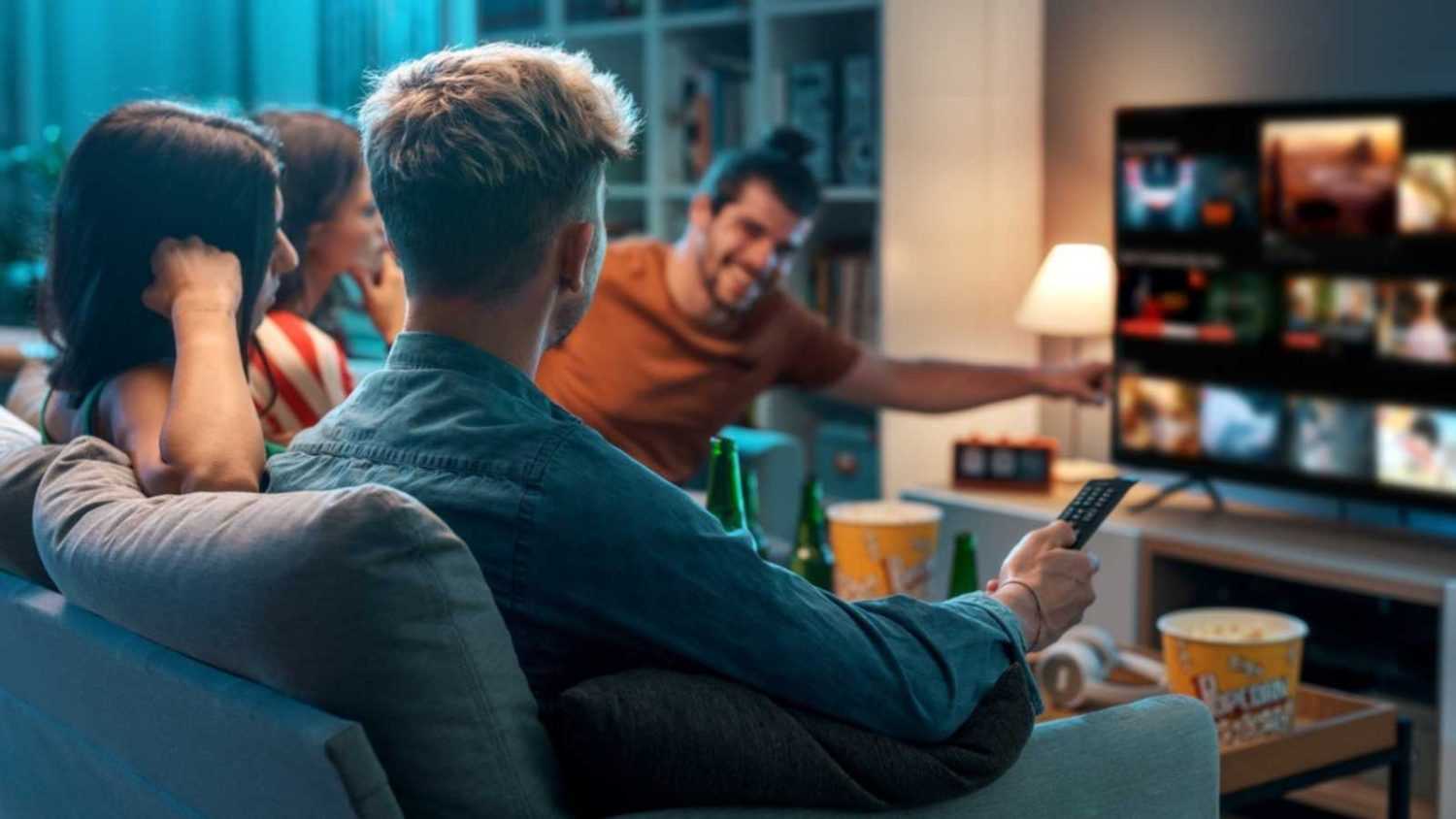 Friends choosing a movie to watch together at home, video on demand concept