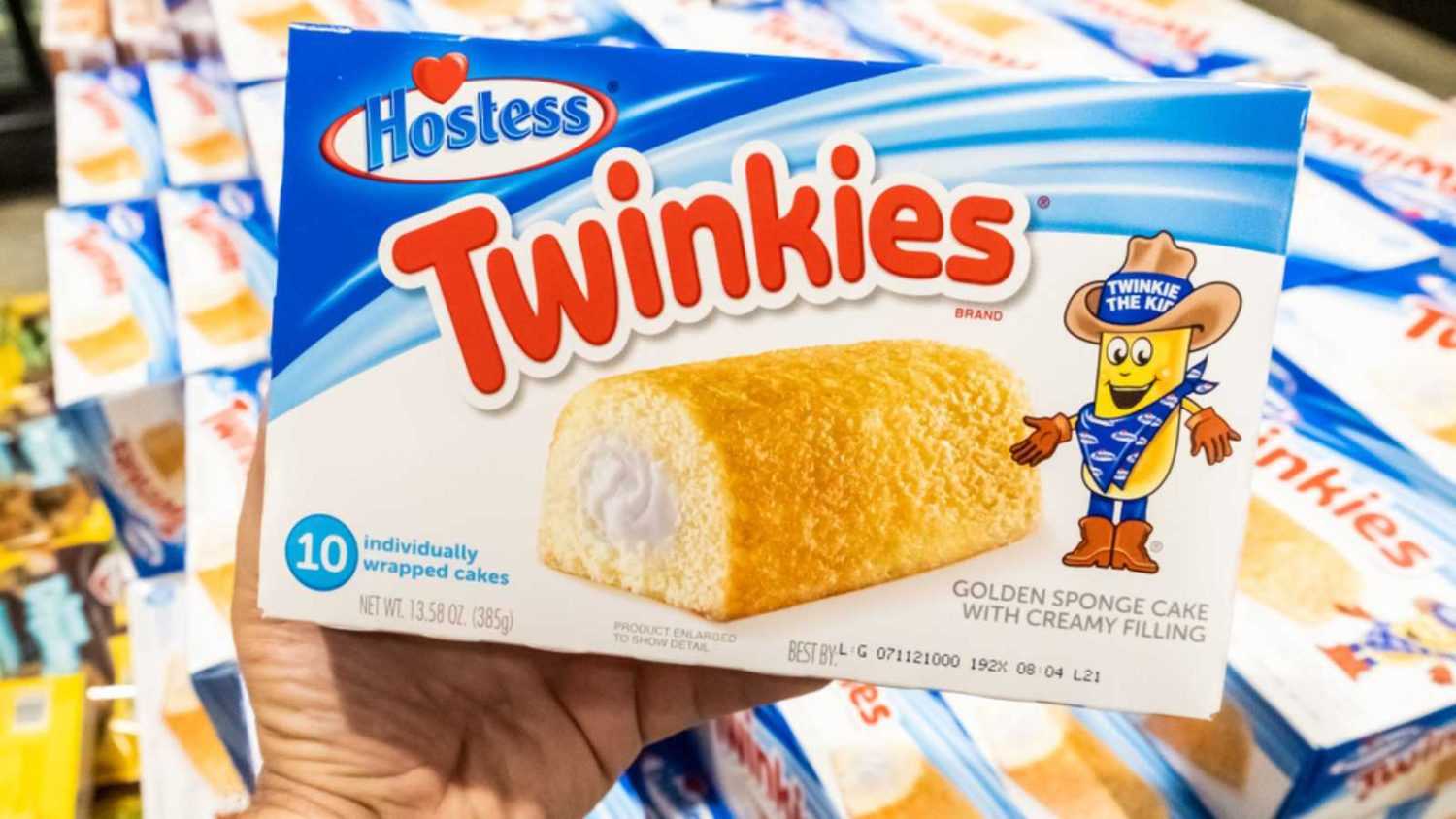 Los Angeles, CA/USA 08/20/2019 Shoppers hand holding a package of Twinkies brand golden sponge cakes with creamy filling in a supermarket aisle