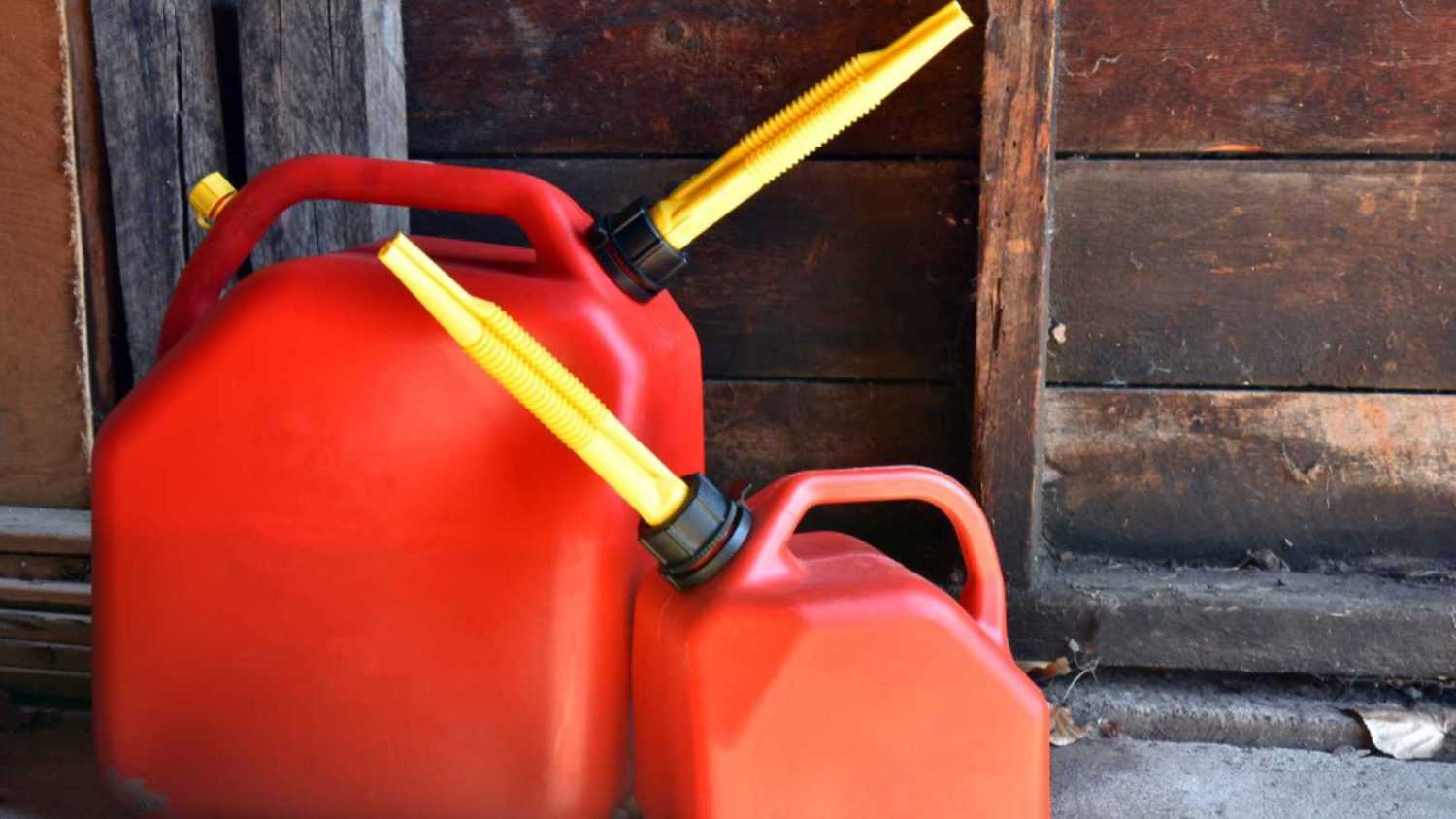 An image of two red plastic gas canisters.