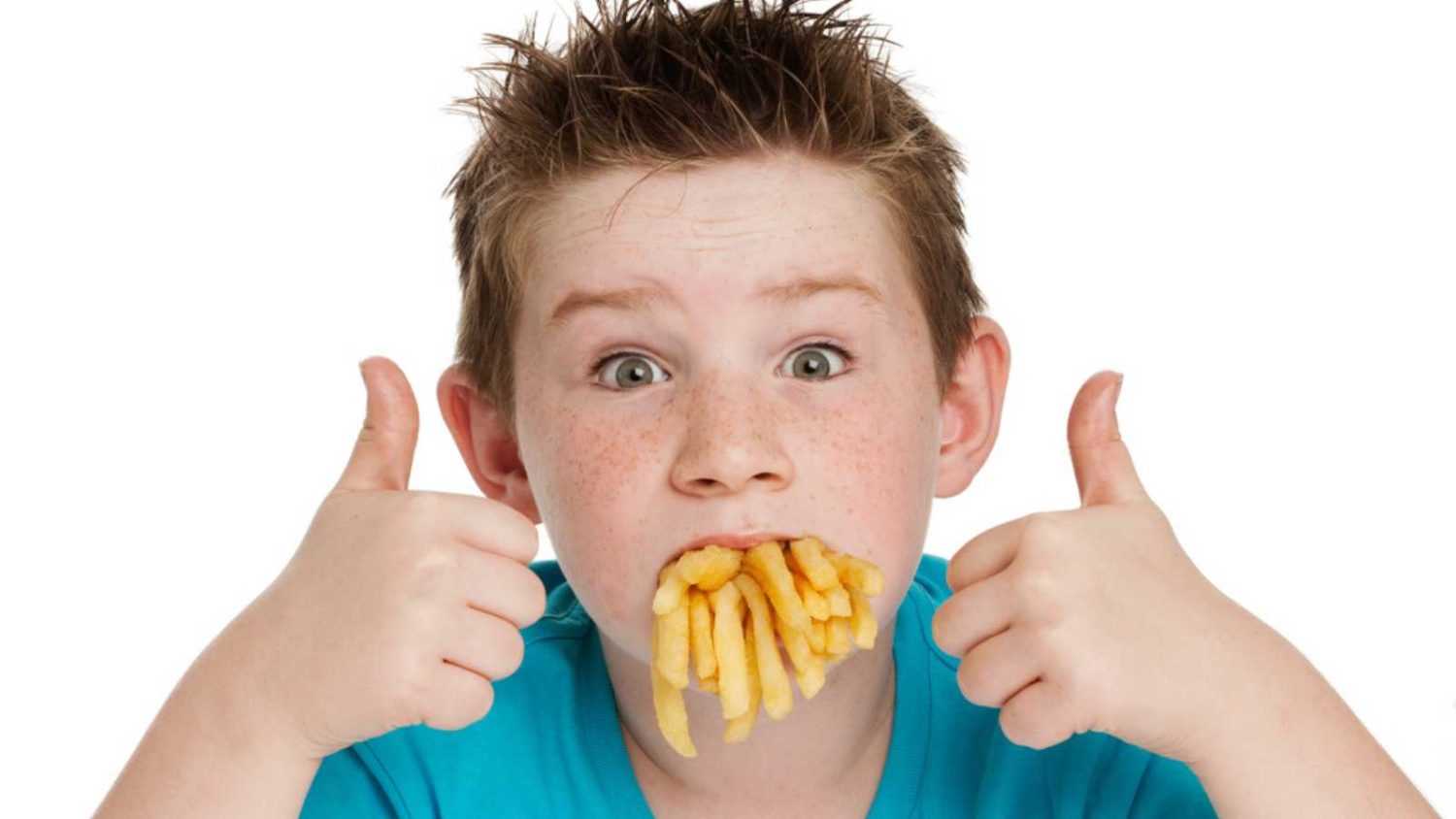 Little boy eating french fries