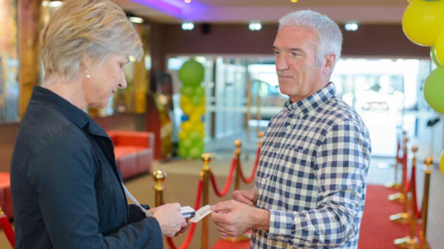 Man giving tickets to Woman