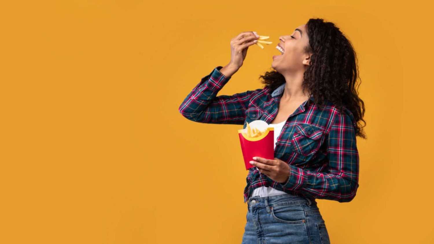 Woman eating french fries