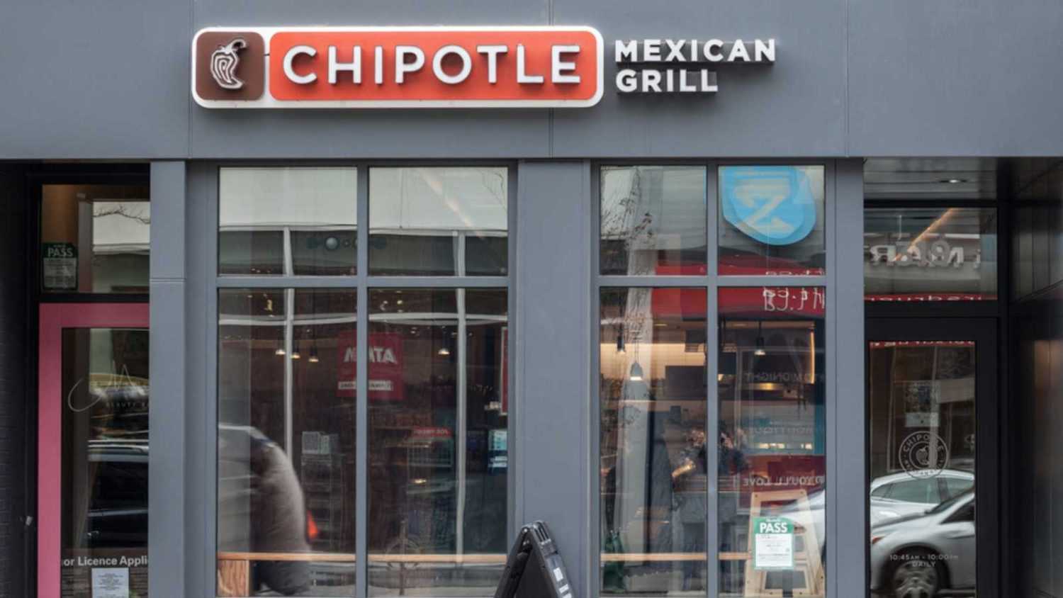 TORONTO, CANADA - NOVEMBER 13, 2018: Chipotle logo in front of their restaurant in Toronto, Ontario. Chipotle is an American fast food brand specialized in grill & Mexican food