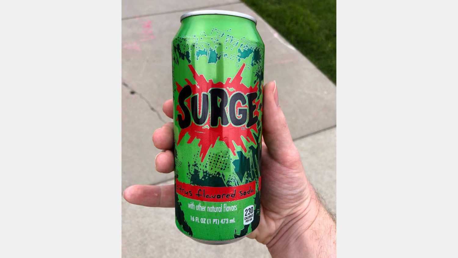 Bloomington, MN/USA - July 1, 2020: Surge soda can being enjoyed by someone outdoors.