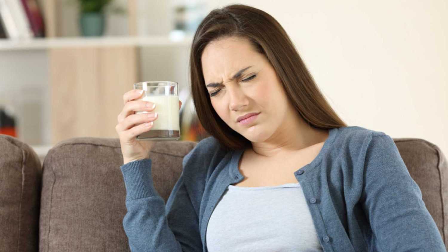 Women drinking milk having stomach ache