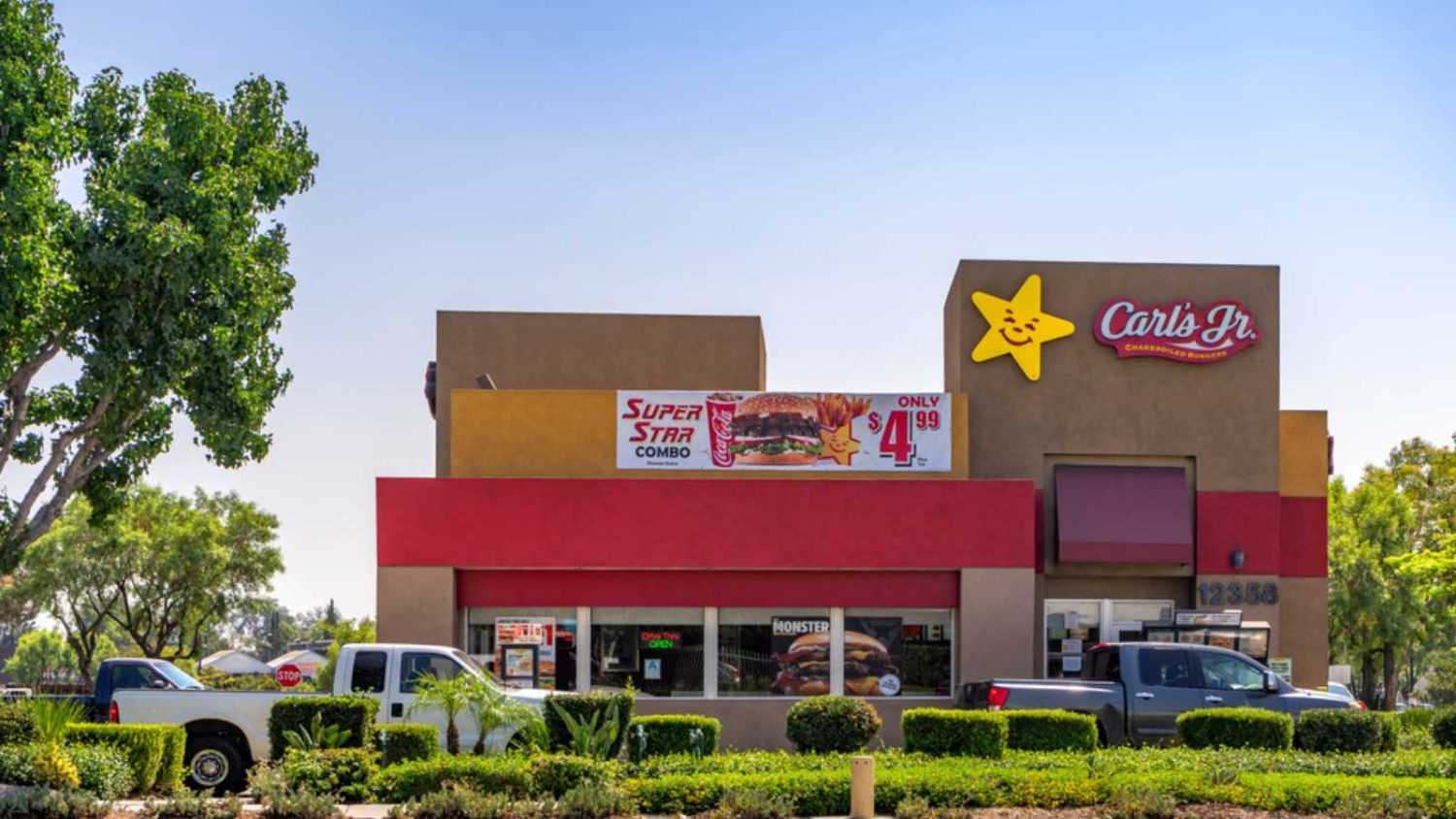 Whittier, CA / USA – September 3, 2020: Exterior view of a Carl’s Jr. restaurant with a drive thru on Washington Blvd. in the City of Whittier, California.